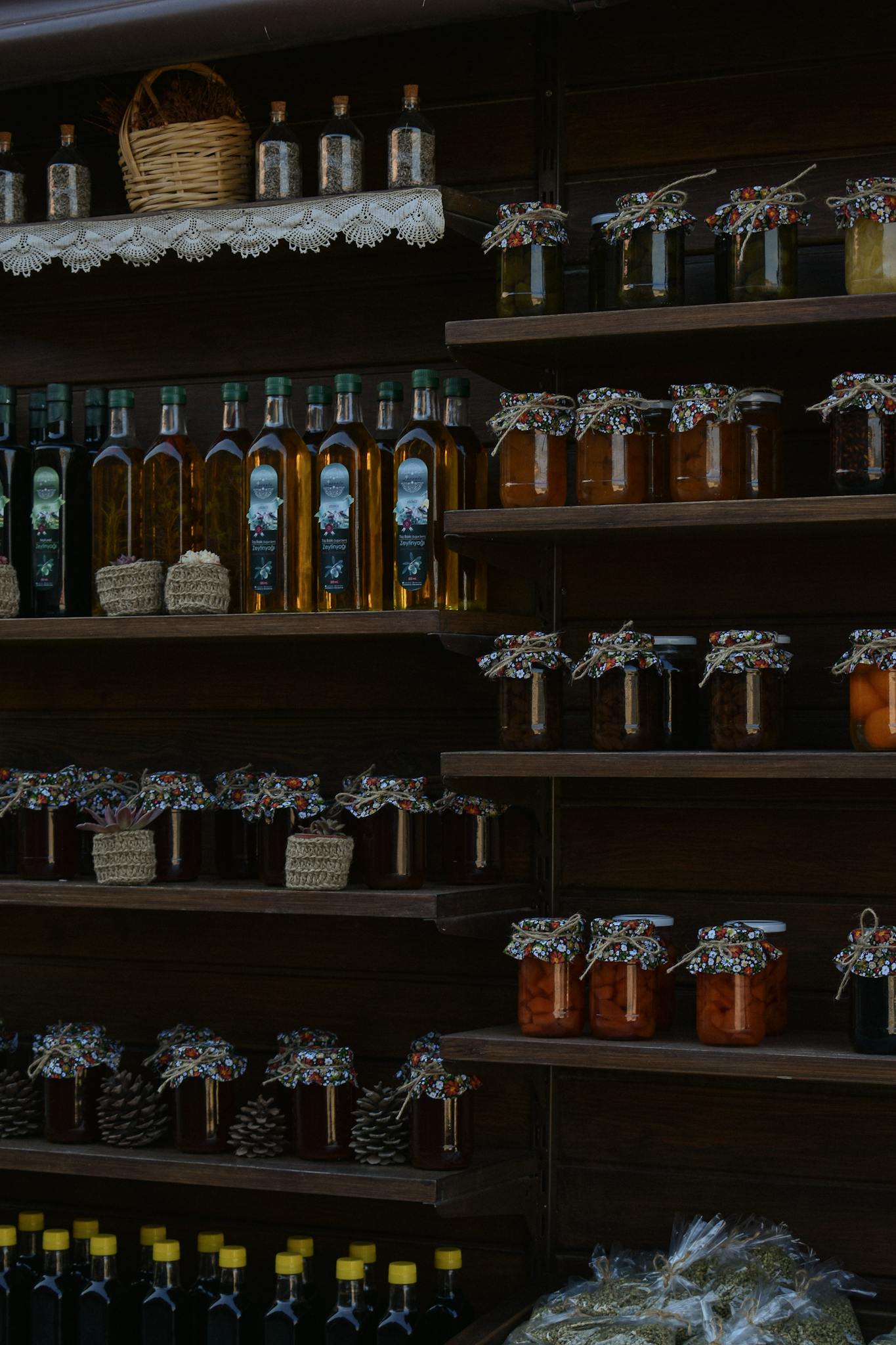 Handcrafted jars and bottles on display at a market stall in Şirince, Turkey, showcasing local products.